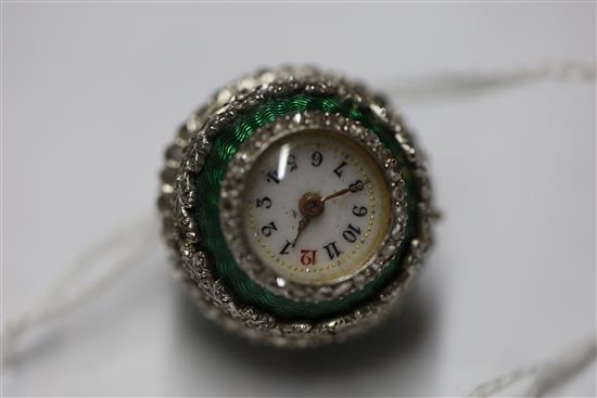 An early 20th century continental silver gilt, green enamel and diamond set ball timepiece pendant,